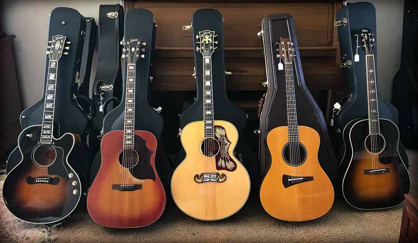 Five Rare Guitars leaning on a piano